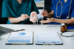 Blog 1 concentrated dentist sitting at table with jaw sam 2025 04 22 01 20 03 utc